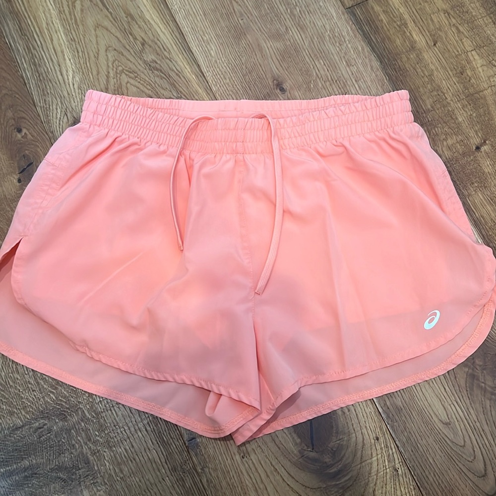 Light pink Asics athletic shorts with spandex liner